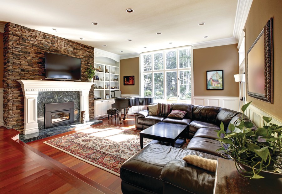 Image is of a brown color scheme living room with ceiling lights.