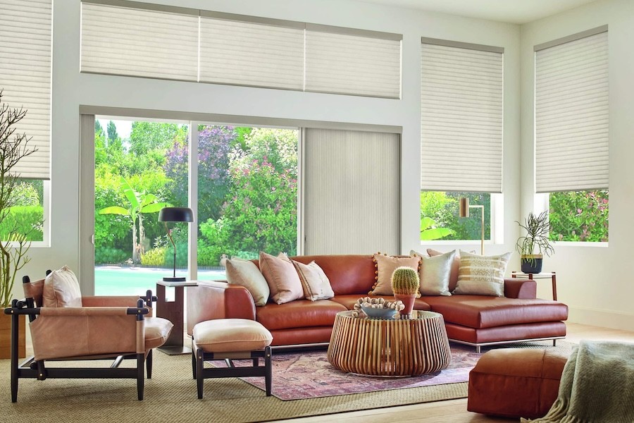 Motorized blinds give a den perfect amounts of natural light.