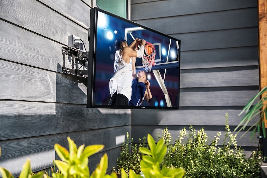 A mounted SunBrite TV displays a basketball game with a crisp image.